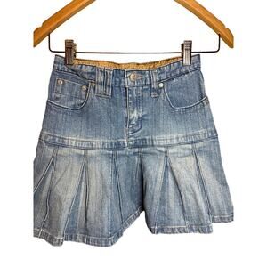 mudd denim pleated miniskirt with attached shorts, reminiscent of Y2K fashion. 